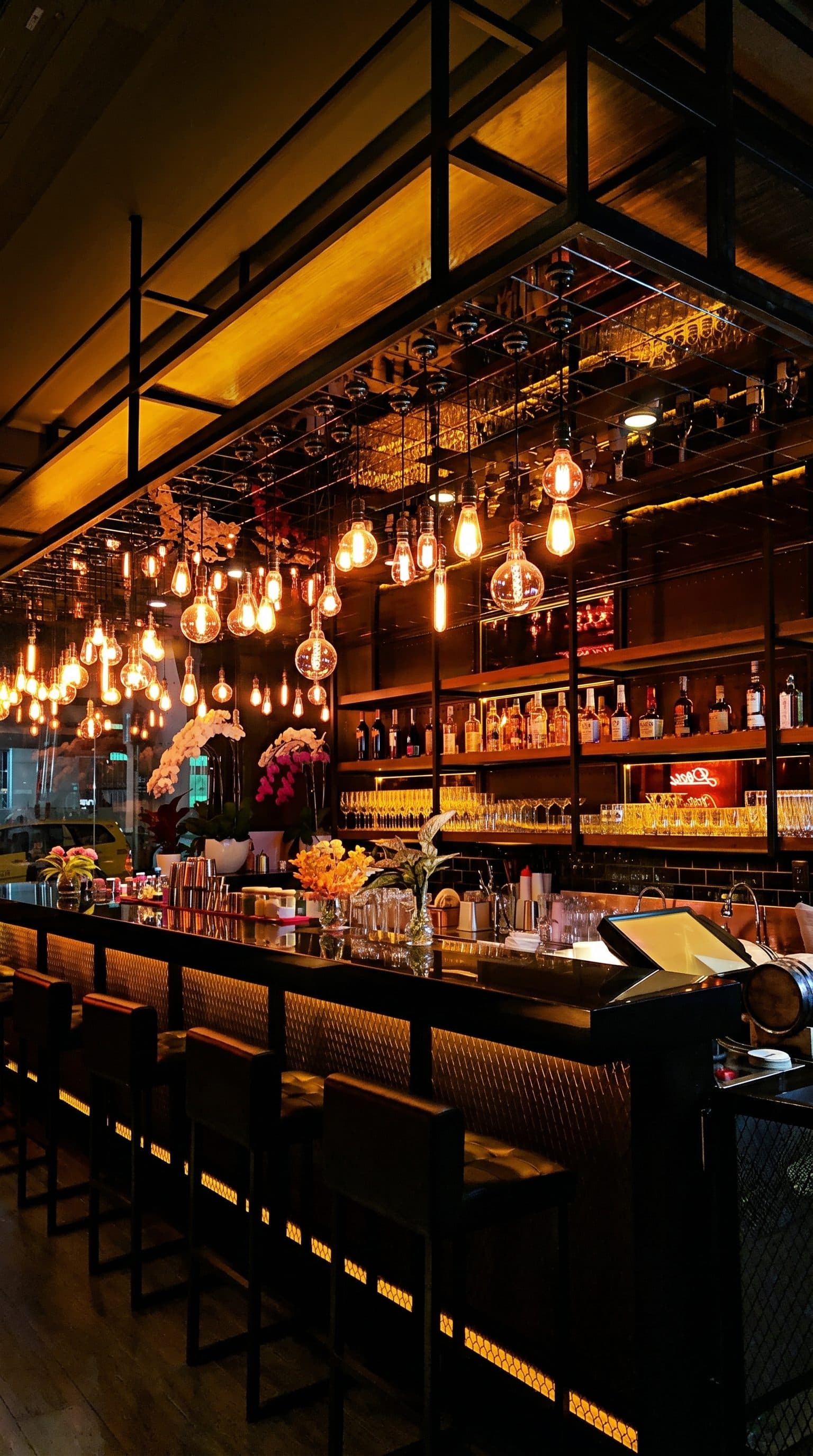 Warm lights above a pub bar before the night begins